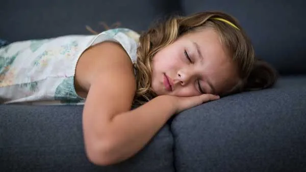 girl sleeping on sofa in living room u5glyht