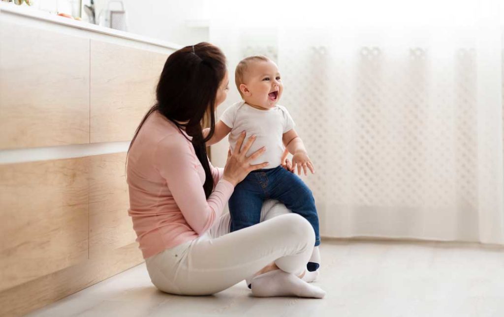 mom talking to baby before dropping off at daycare