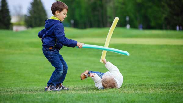 preschool boys fighting with toy swords PDB55GX