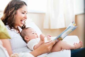 stay at home mother reading a book to her child