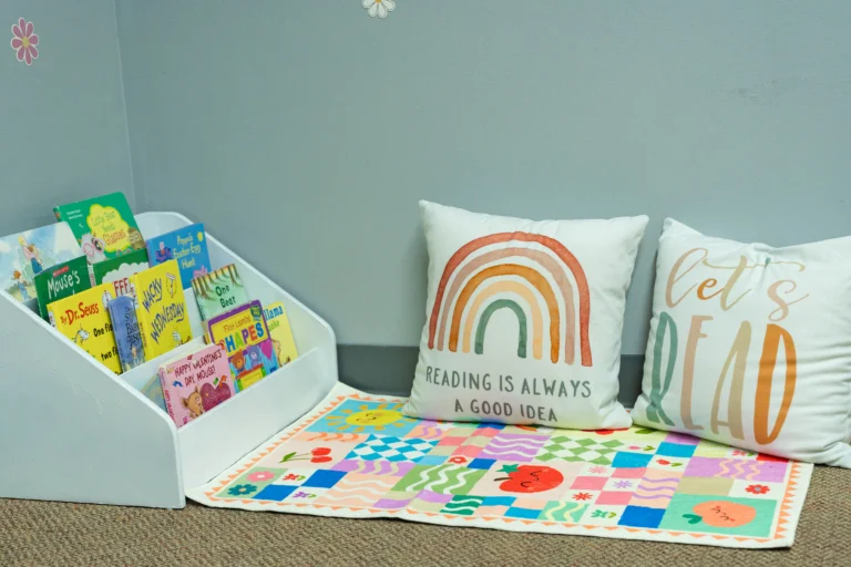 Classroom reading nook with picture books and pillows