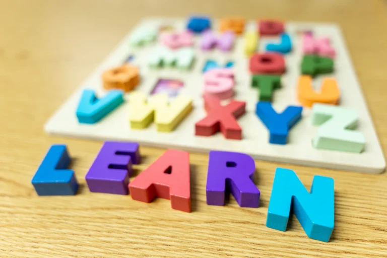 Alphabet puzzle letters spelling LEARN in a preschool classroom