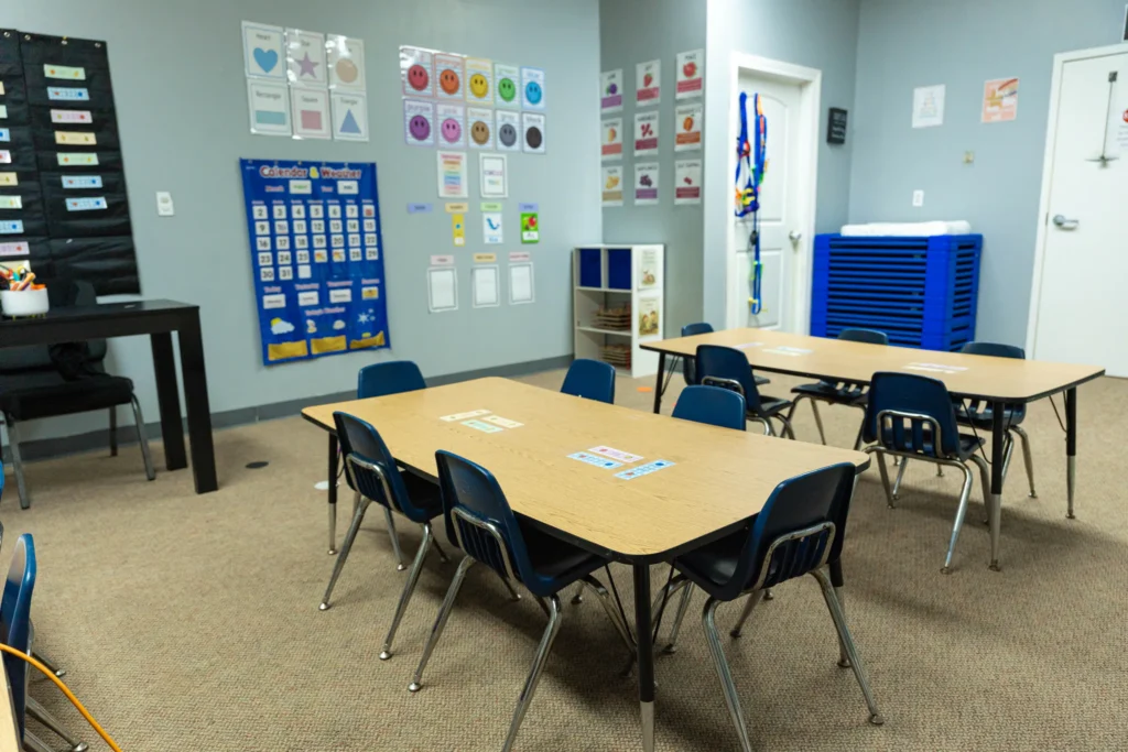 Classroom with small tables and learning charts at The Way PDO