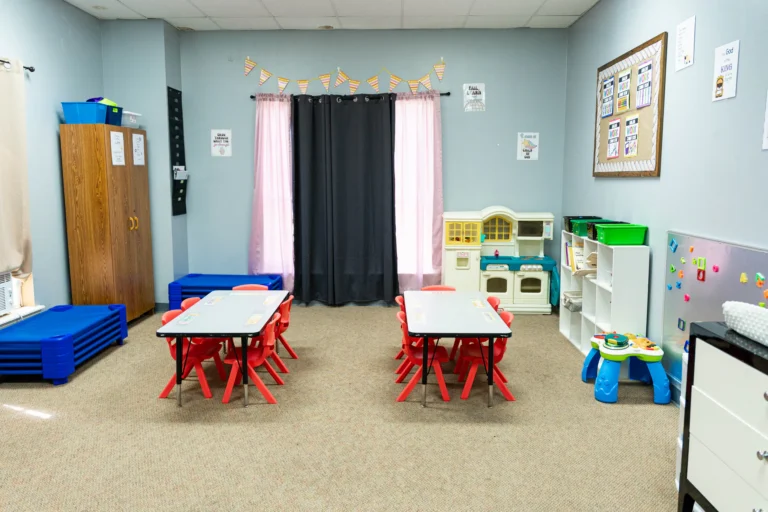 Preschool classroom with child-size tables and nap mats