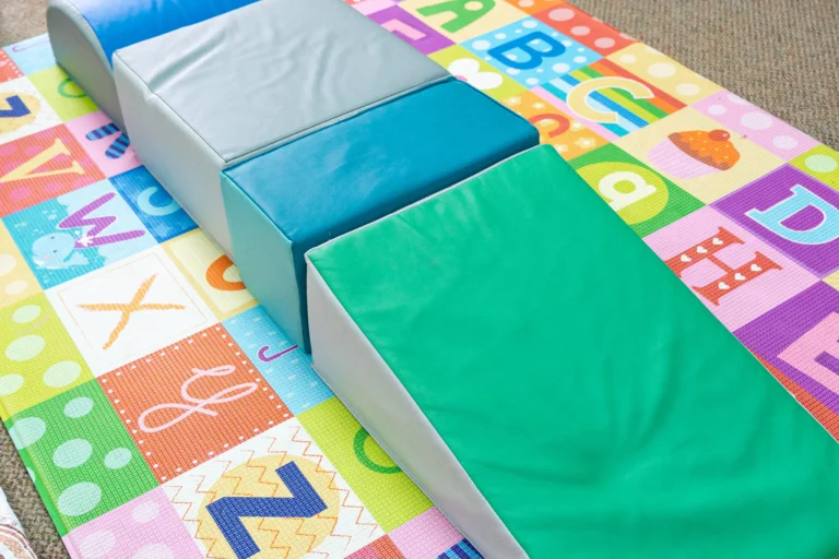 Soft foam climbing ramps on a play mat for infants