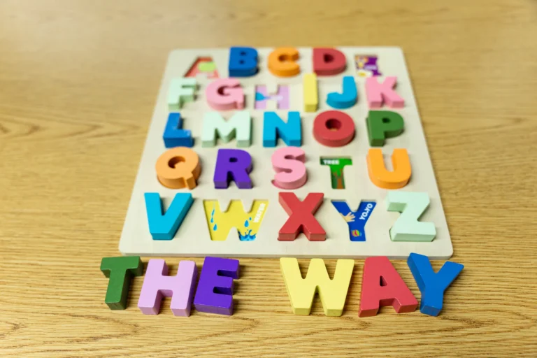 Wooden alphabet puzzle spelling The Way on a classroom table